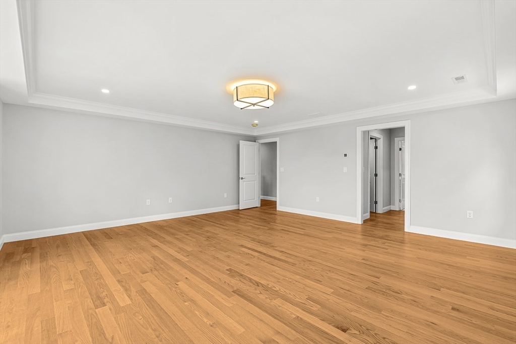 26 Flagg Street Woburn, MA 01801 - Photo 24 of 41 a view of an empty room with wooden floor and a window