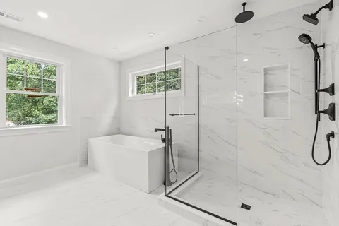 a bathroom with a shower bathtub and window