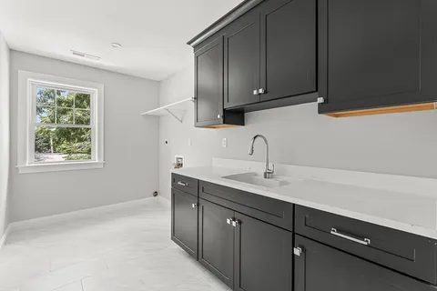 a kitchen with a sink cabinets and window