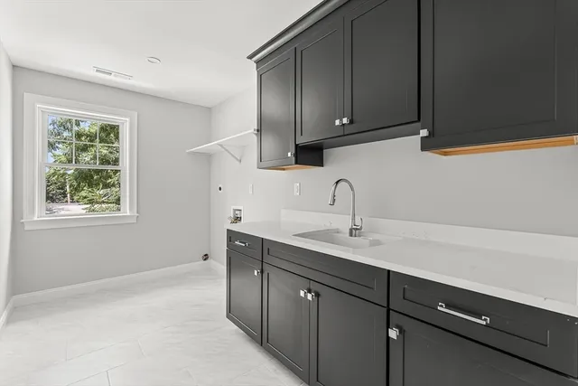 a kitchen with a sink cabinets and window
