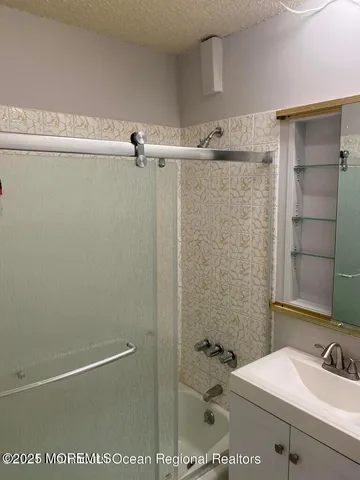 a bathroom with a sink and shower