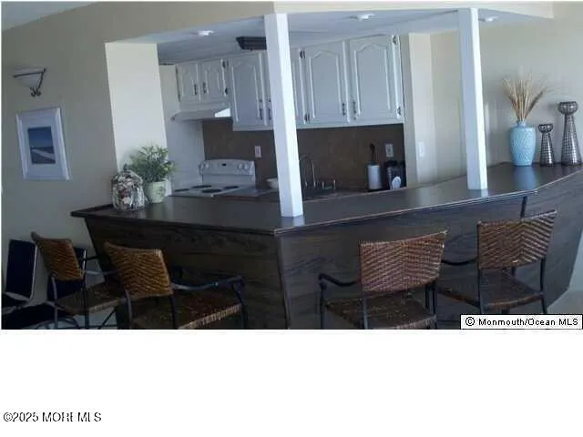 a kitchen with a table chairs and a refrigerator