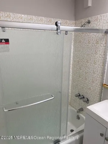 a bathroom with a shower and a sink
