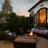 a outdoor living space with patio furniture and a fireplace