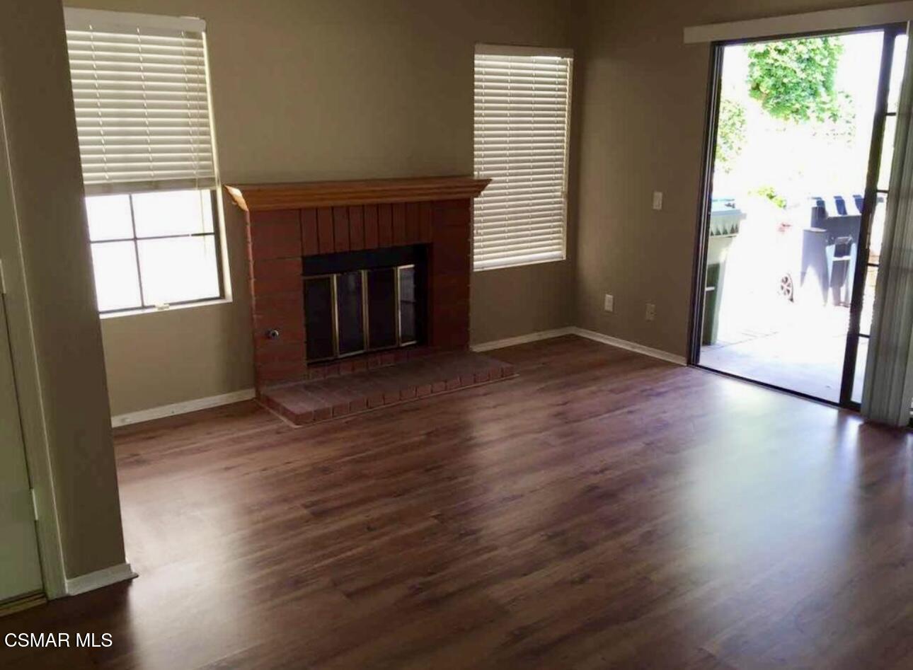 634 Llanerch Lane Simi Valley, CA 93065 - Photo 6 of 9 an empty room with wooden floor and a fireplace