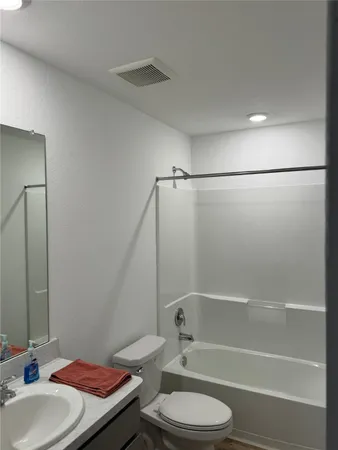 a bathroom with a sink a toilet and a bathtub