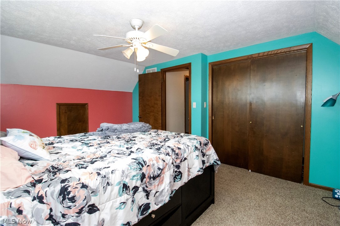 1644 Moore Road Wooster, OH 44691 - Photo 22 of 30 Bedroom with light carpet, a textured ceiling, ceiling fan, and vaulted ceiling