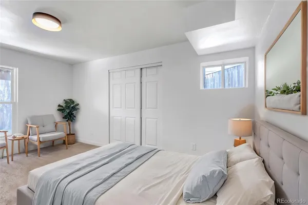 a bedroom with a bed and a potted plant