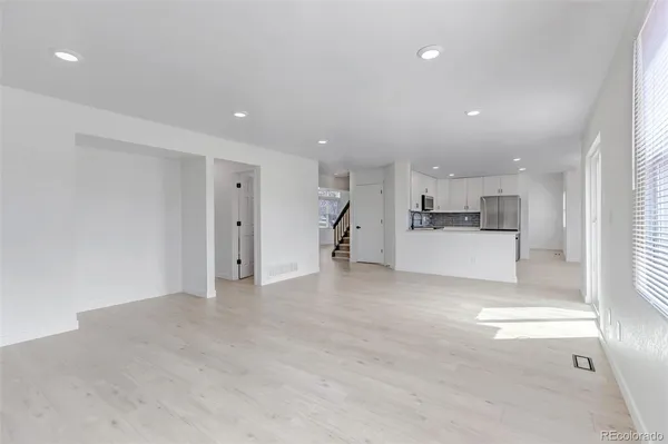 a kitchen with stainless steel appliances granite countertop a stove top oven a sink and a microwave