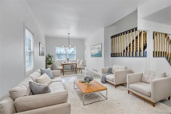 a living room with furniture and a chandelier