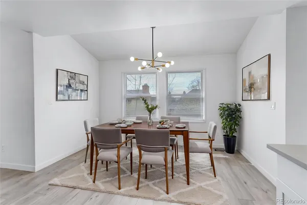 a view of a dining room with furniture window and wooden floor