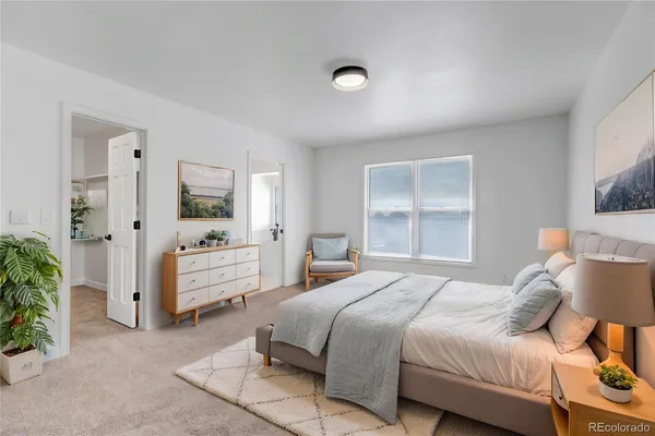 a bedroom with a bed and a couch