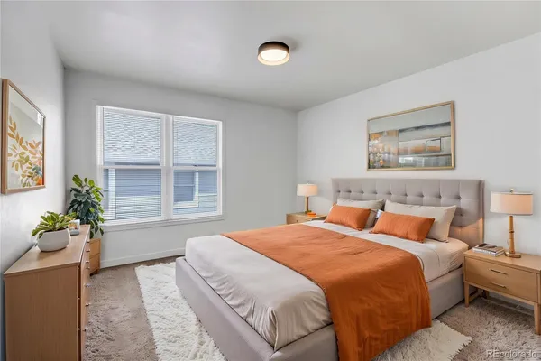 a bedroom with bed and a window