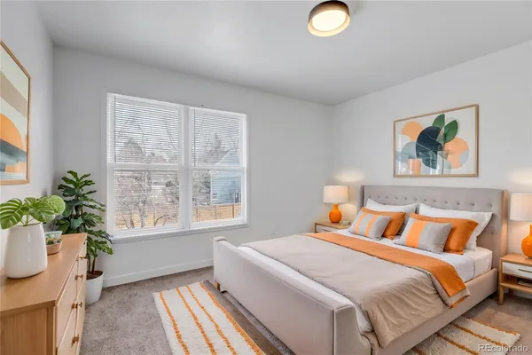 a bedroom with bed and wooden floor