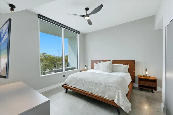 a bedroom with a bed and a window