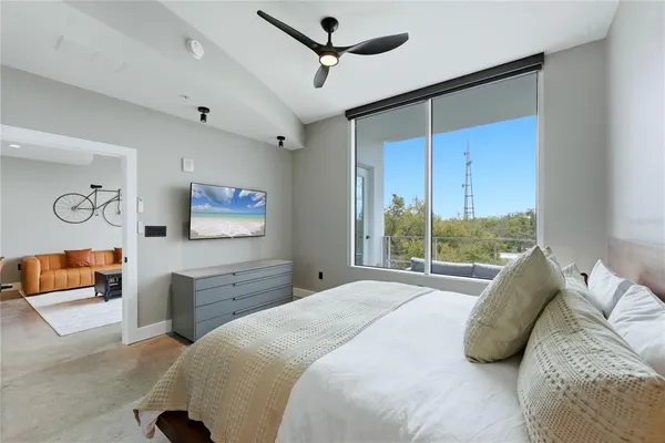 a bedroom with a large bed and a window