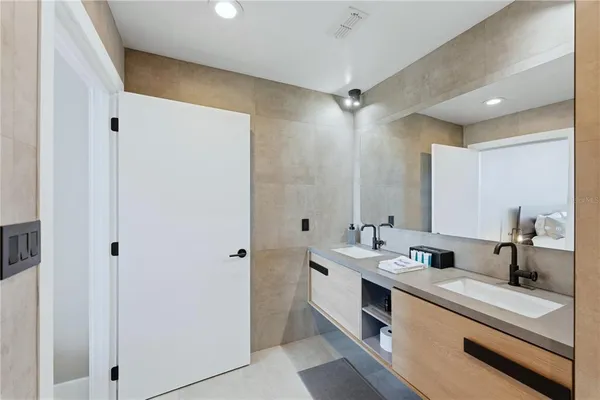 a bathroom with a double vanity sink mirror and