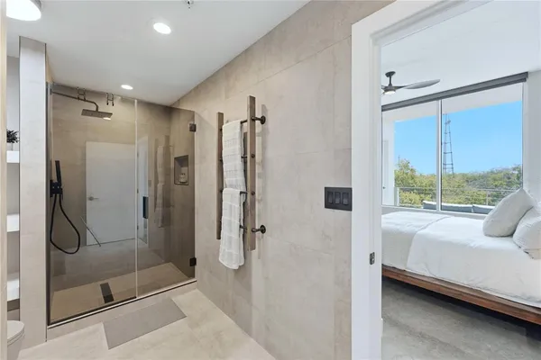 a bathroom with a shower and a glass door shower