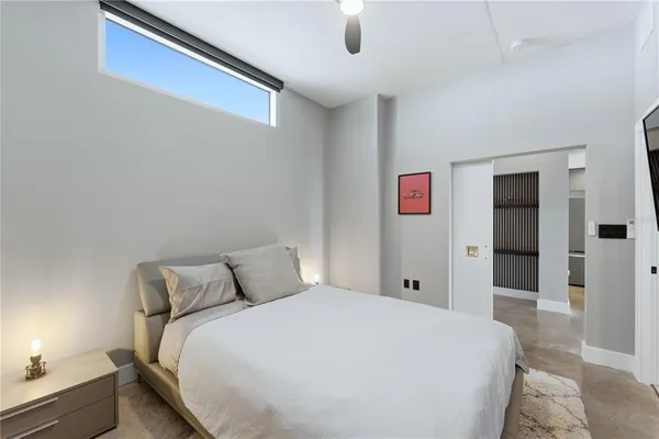 a bedroom with a large bed and a chandelier