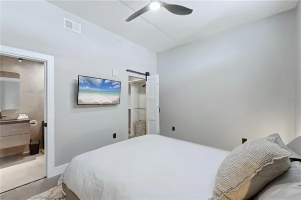 a bedroom with a bed and a painting on the wall