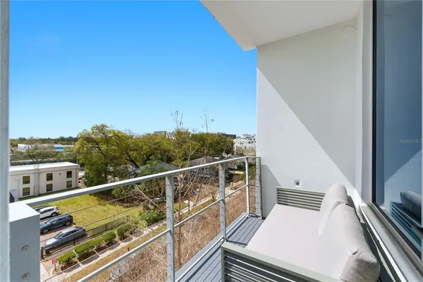 a view of a balcony with chairs