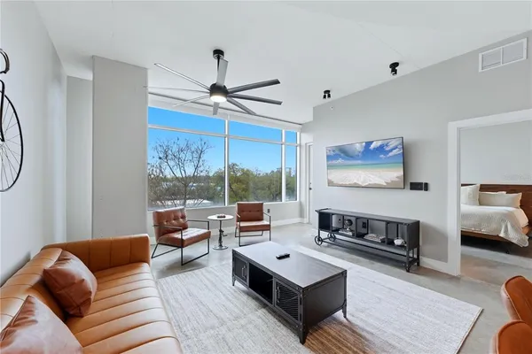 a living room with furniture a rug and a chandelier