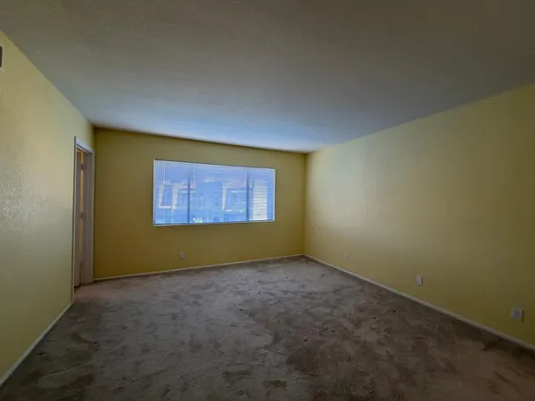an empty room with a empty space and a window