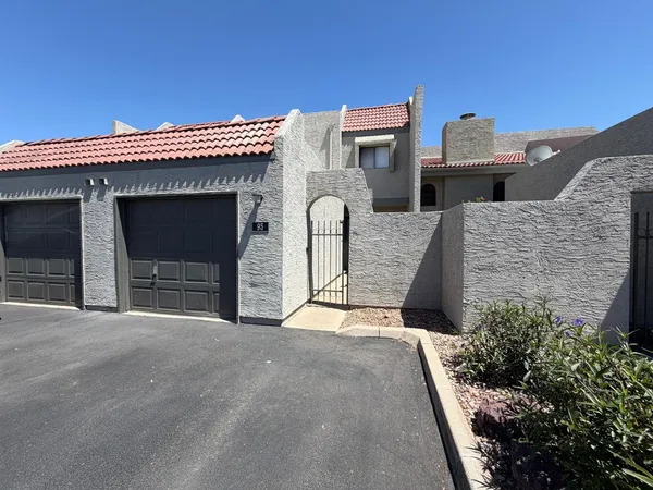 a view of a house with a balcony and a garage