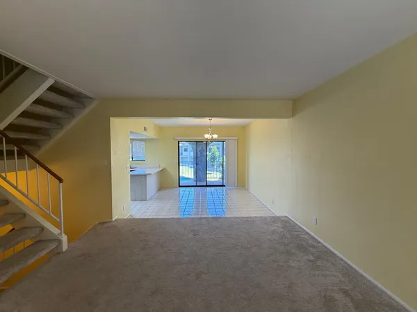 a view of hallway with wooden floor and cabinet