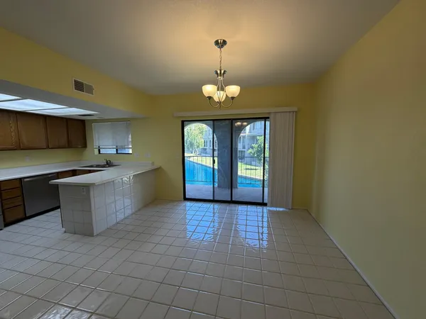 a view of a kitchen with a sink dishwasher and cabinets