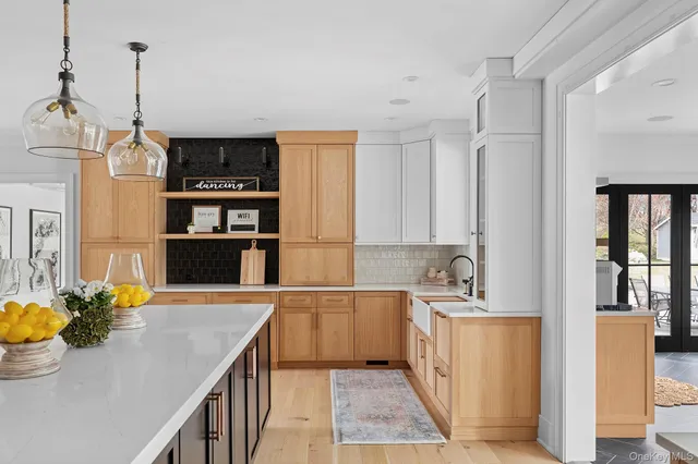 a view of a livingroom with furniture wooden floor and chandelier