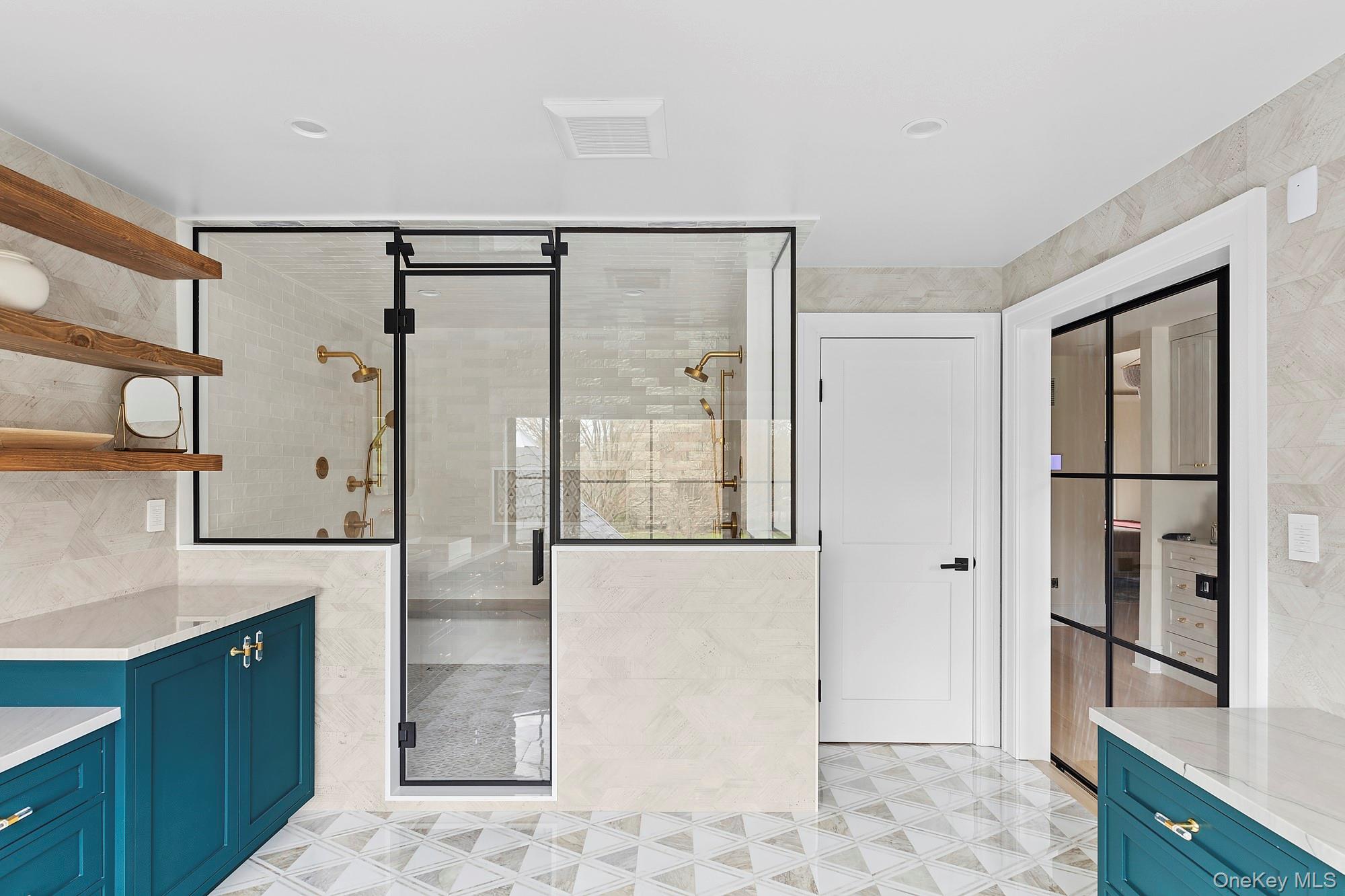 89 Pound Hollow Road Glen Head, NY 11545 - Photo 20 of 26 a bathroom with a glass shower door and a sink
