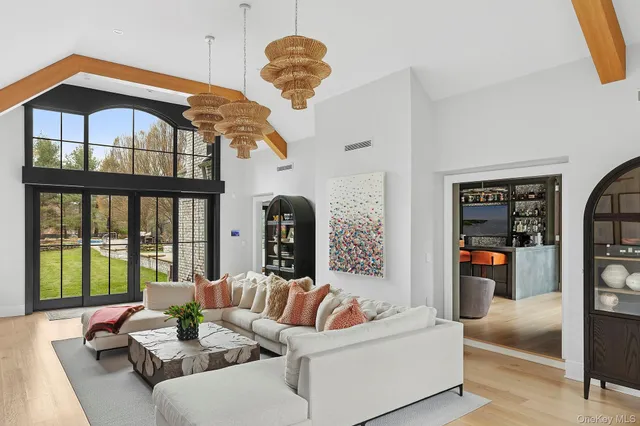 a living room with furniture fireplace and a large window