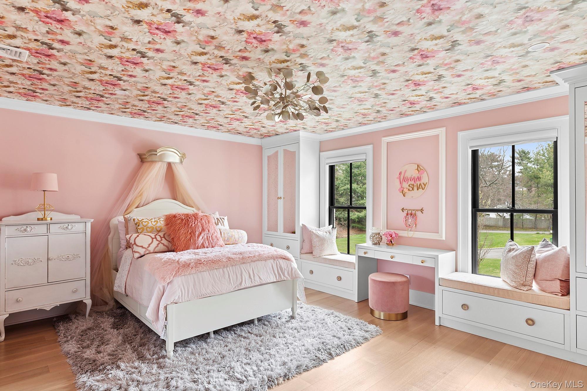 89 Pound Hollow Road Glen Head, NY 11545 - Photo 21 of 26 a room with a bed and a chandelier