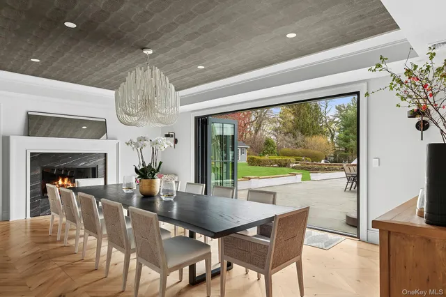 a dining room with furniture a chandelier and wooden floor