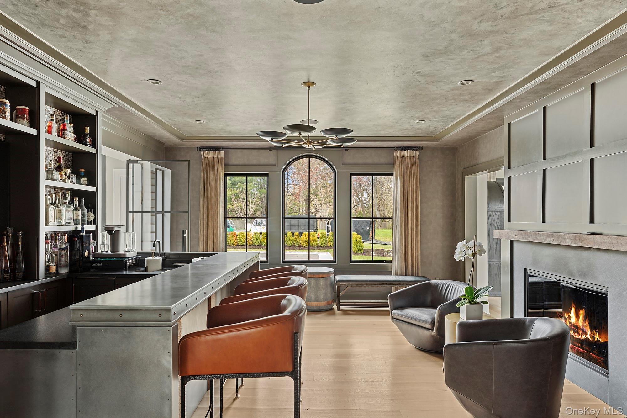 89 Pound Hollow Road Glen Head, NY 11545 - Photo 7 of 26 a living room with furniture a fireplace and a chandelier