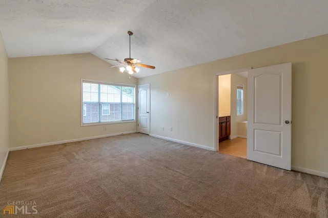 an empty room with windows and entrance