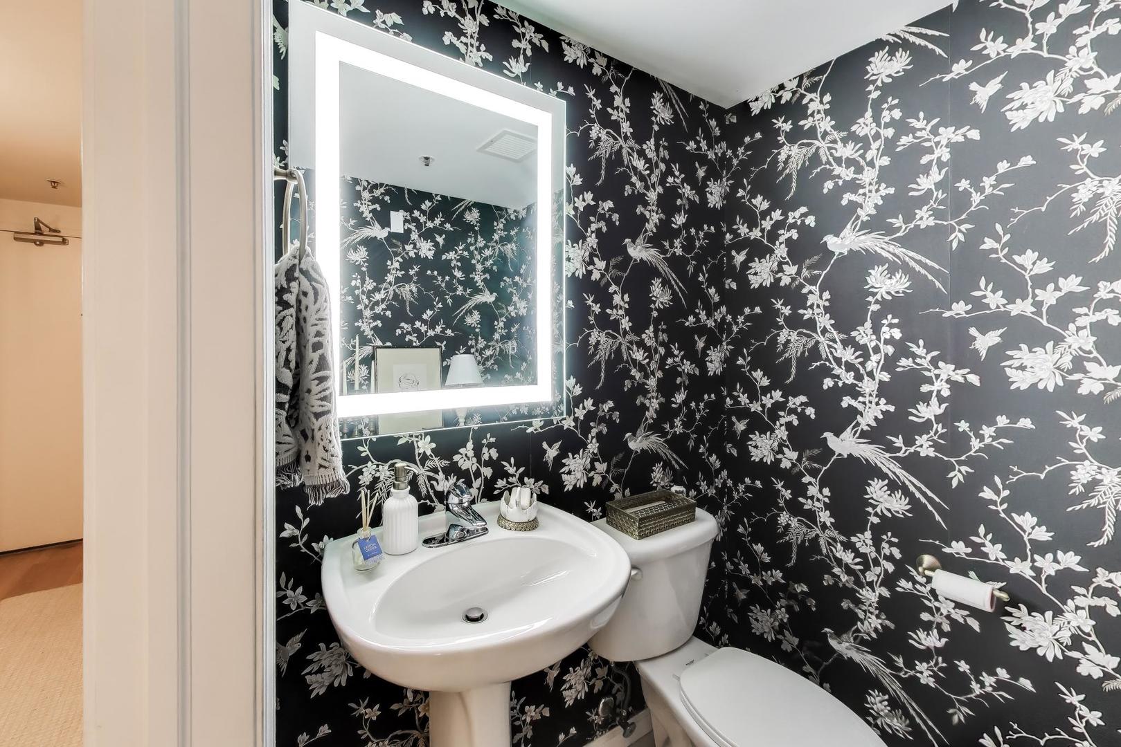 4848 North Sheridan Road, Unit 203 Chicago, IL 60640 - Photo 15 of 32 a bathroom with a sink toilet and a mirror
