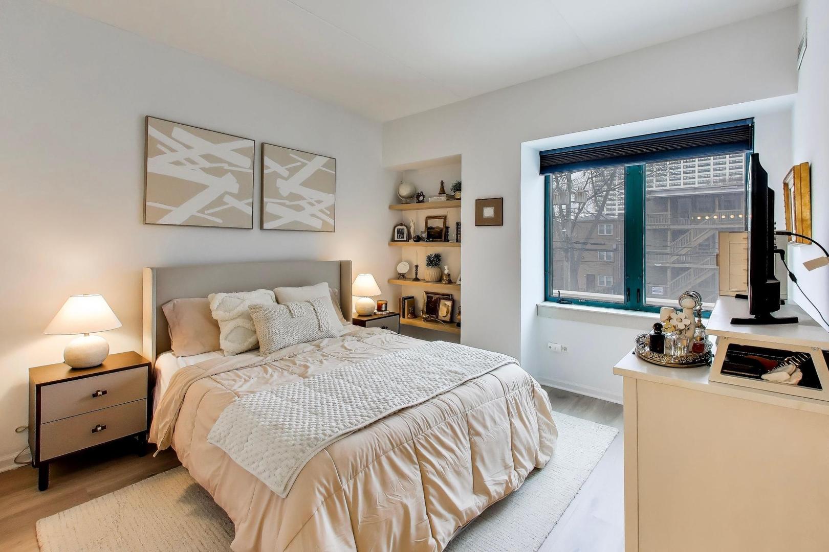 4848 North Sheridan Road, Unit 203 Chicago, IL 60640 - Photo 16 of 32 a bedroom with a bed and a large window