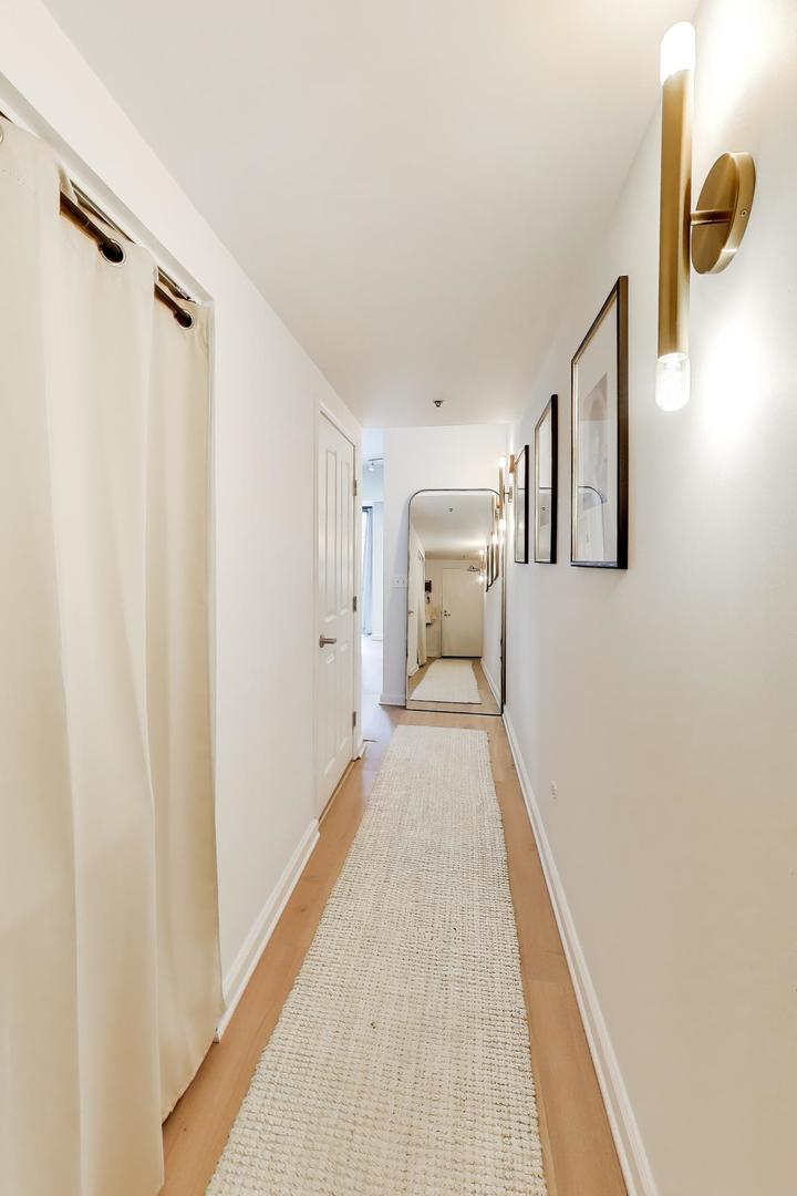 4848 North Sheridan Road, Unit 203 Chicago, IL 60640 - Photo 19 of 32 a view of a hallway with wooden floor
