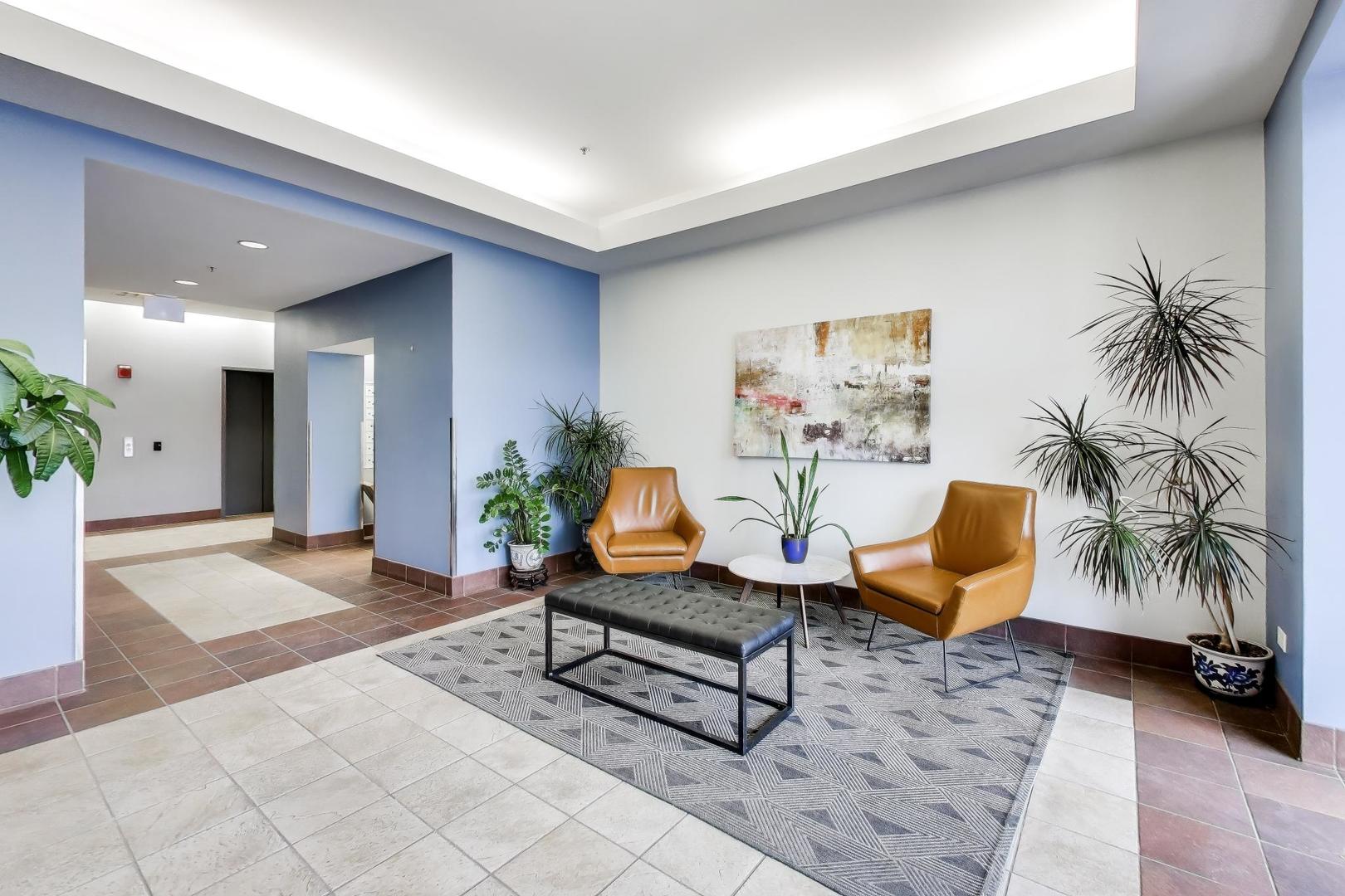 4848 North Sheridan Road, Unit 203 Chicago, IL 60640 - Photo 2 of 32 a living room with furniture and a potted plant