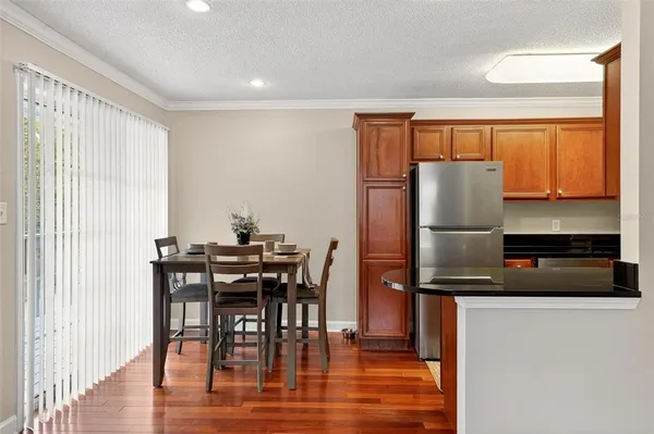 a kitchen with a refrigerator a stove and a dining table