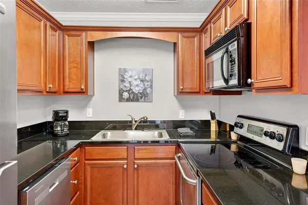 a kitchen with stainless steel appliances granite countertop a stove and cabinets