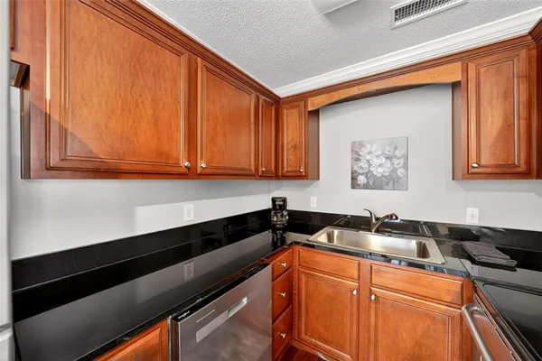 a kitchen with stainless steel appliances granite countertop a sink stove and cabinets