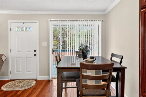 a view of a dining room with furniture and wooden floor