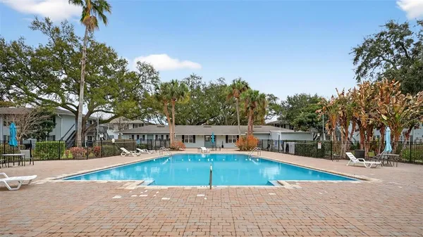 a view of a swimming pool with trees in the background
