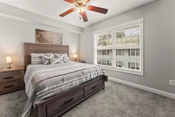 a spacious bedroom with a bed and a window