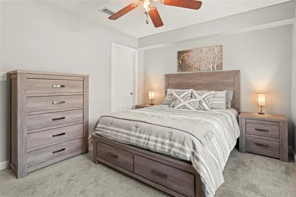 a bedroom with a bed and a dresser