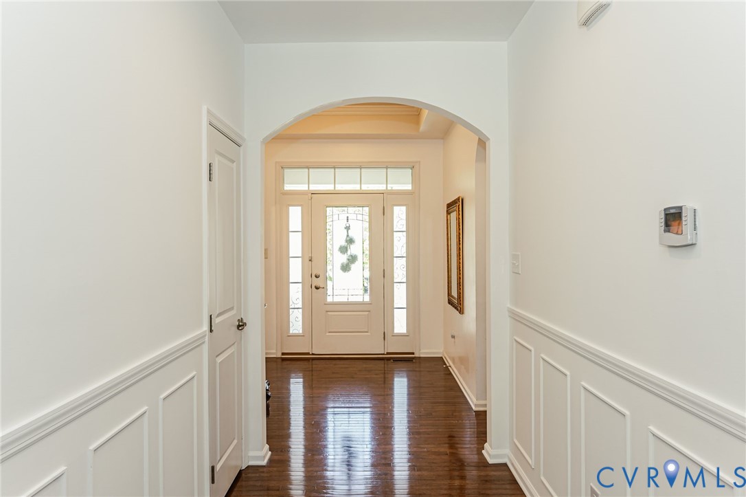 7435 Wicks Road Williamsburg, VA 23188 - Photo 13 of 82 Foyer featuring wood-finish flooring, wainscoting,
