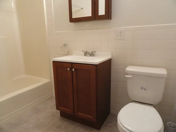 a bathroom with a sink a toilet and bathtub